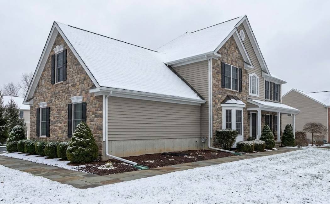 Protecting home foundation and landscape from winter runoff with gutter guards