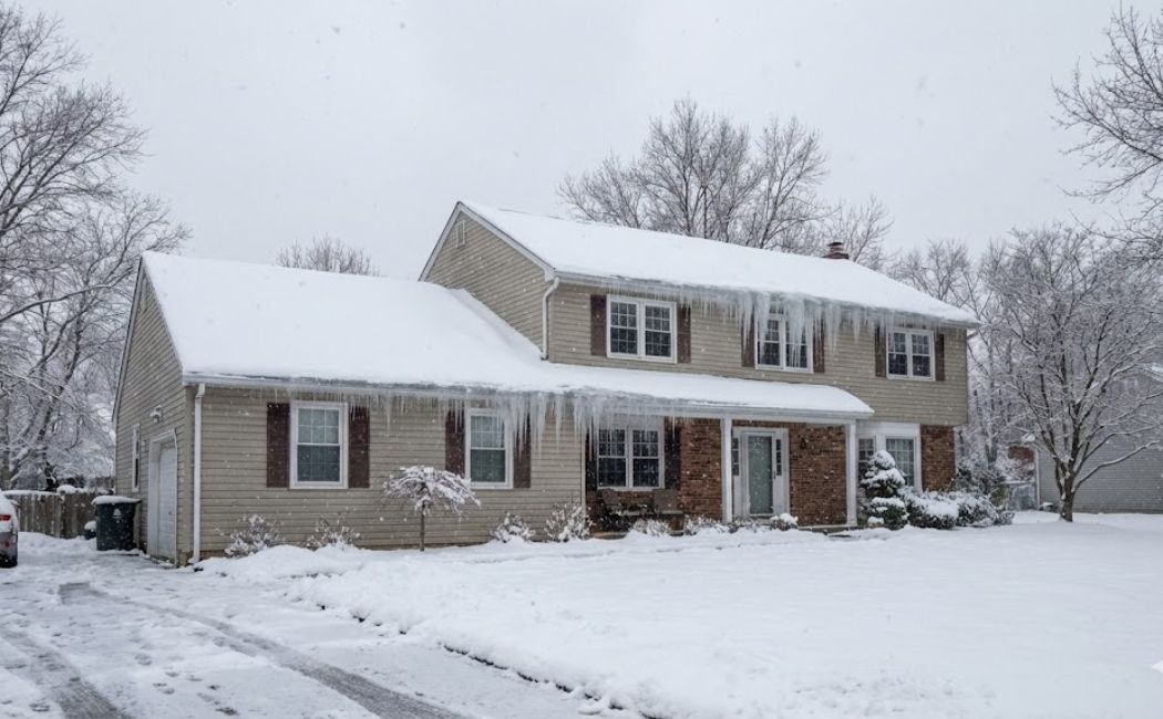 Preparing a New Jersey home for February winter storms with snow covered roof and ice dams